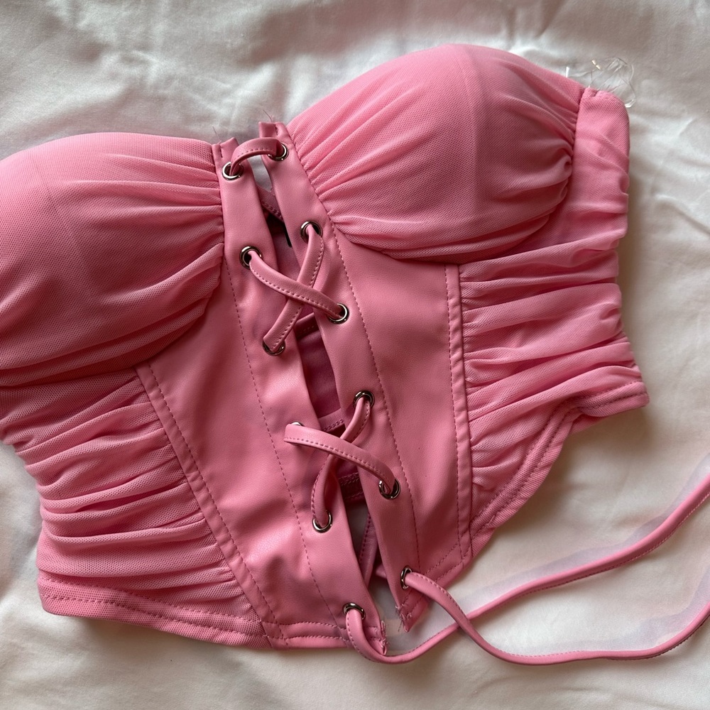 Bubblegum pink corset, size small. 100% polyester lining and spandex material.